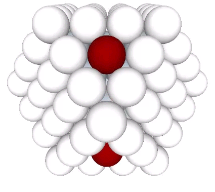 Three shells of radially close-packed spheres around a nucleus, forming a VE with eight potential nuclei (red) at the centers of its eight triangular facets.