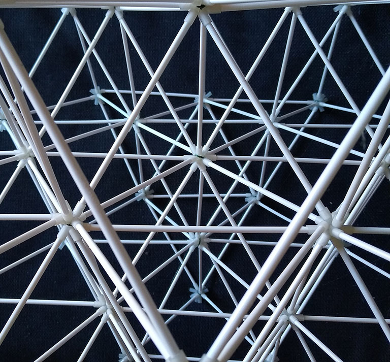 Photograph of the isotropic vector matrix with struts made from cake-pop sticks and connectors made from silicone rubber tubing.