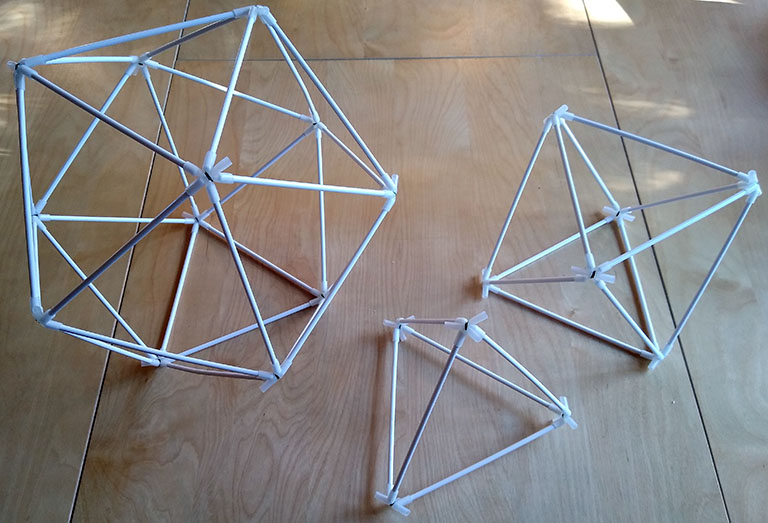 Photograph of three sample models: icosahedron; octahedron; and tetrahedron, made with cake-pop and connectors made from silicone rubber tubing.